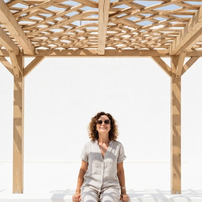 User enjoying an outdoor space under a pergola
